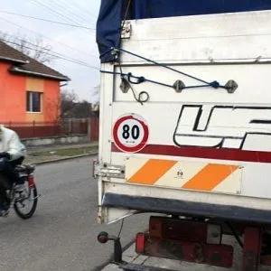 Oaida passes by a truck as he tests his bicycle propelled with a self-built jet engine on a road in the back of his house in Deva