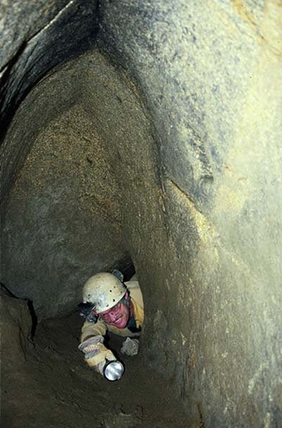 Man exploring a horizontal passage