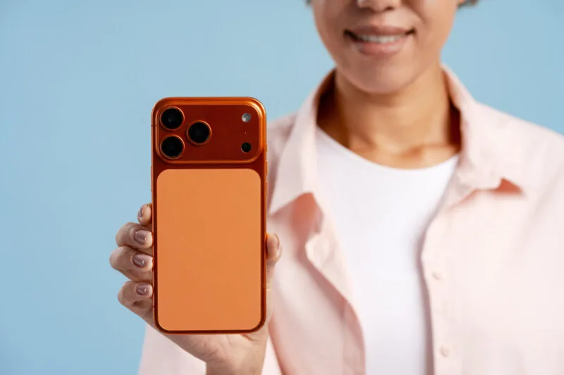 Woman showing smartphone with orange case 03 26 23 45 10 utc