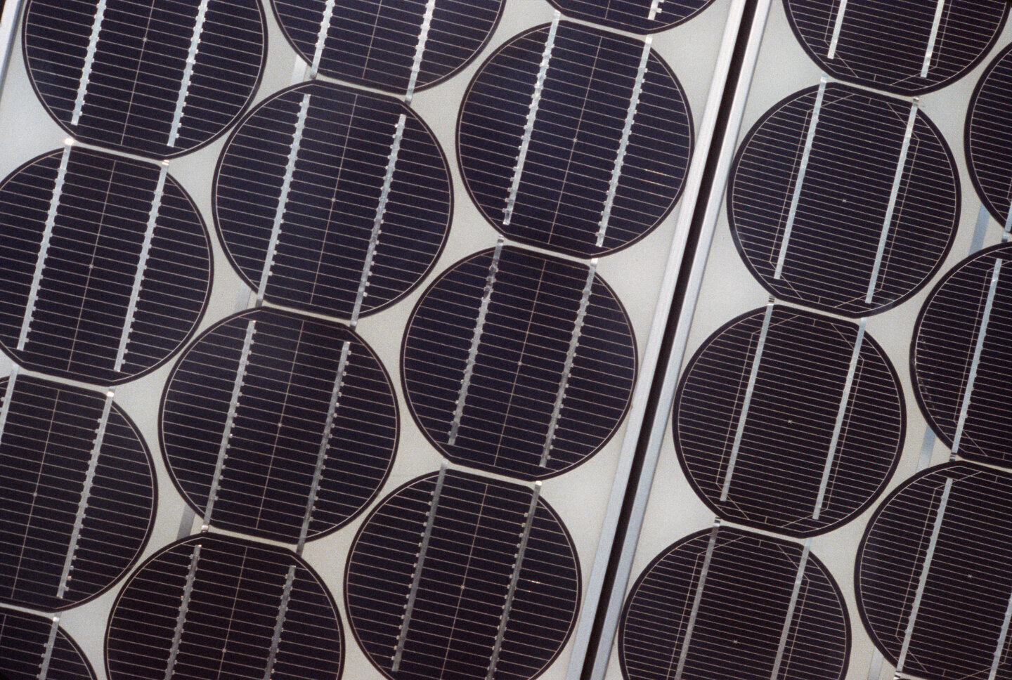 Prim-plan al unei celule fotovoltaice instalate pe acoperișul unei case, parte a unui experiment de conversie a energiei solare