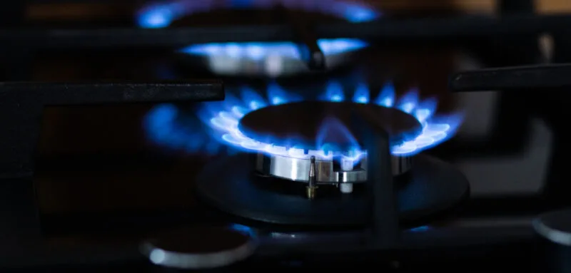 Glowing blue flame on a dark cooktop 03 25 08 40 05 utc