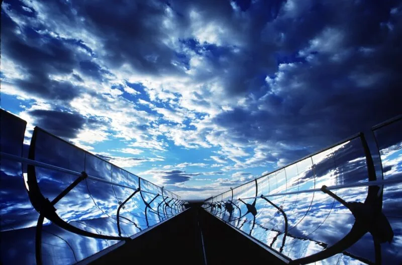 Câmp de panouri solare sub cer senin, ilustrând conversia energiei luminoase