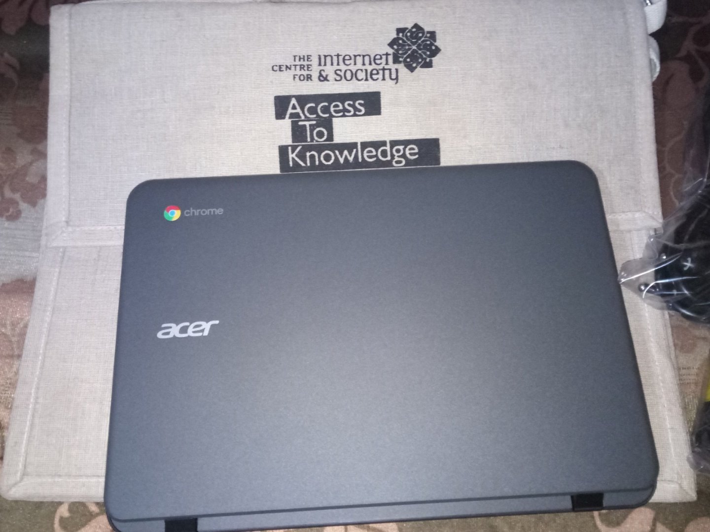 Laptop Chromebook deschis pe un birou, cu ecranul pornit