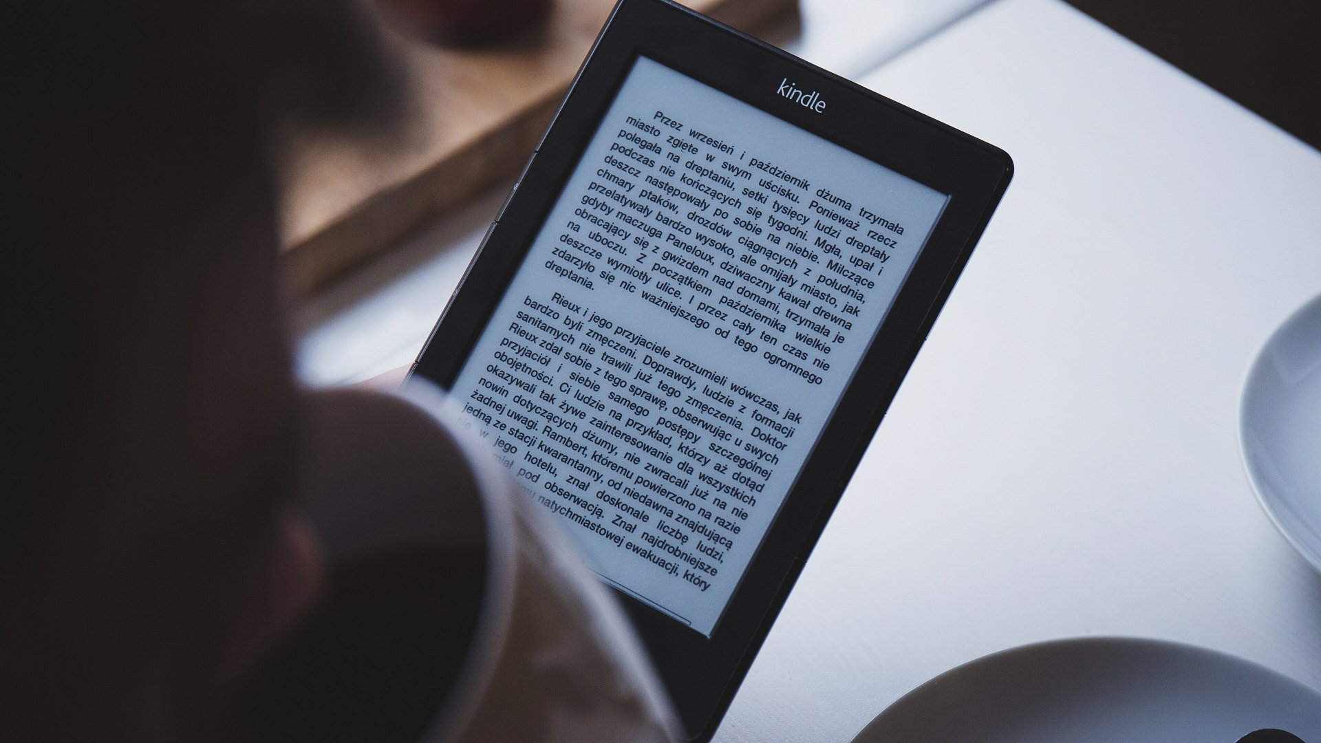 Persoană care citește pe un e-reader cu ecran E Ink, tehnologie îmbunătățită de Kaleido 4 pentru variantele color